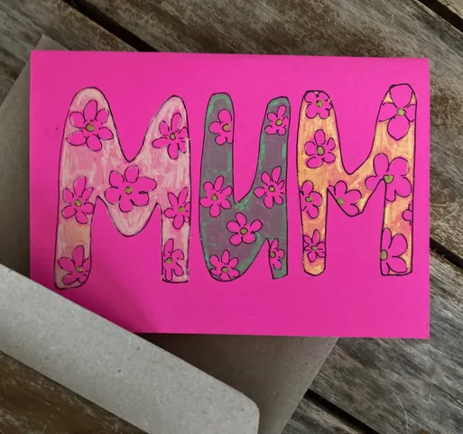 Mothers day Card. The word Mum written on a bright pink cardstock