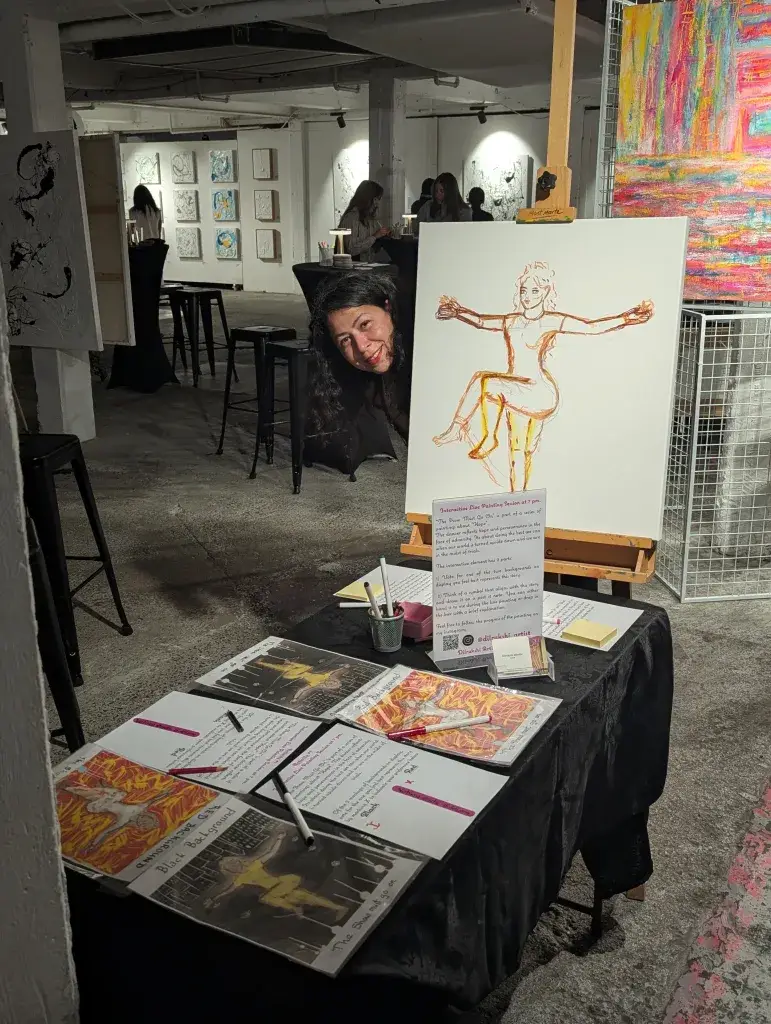 Dilrukshi mendis peeking from behind a canvas at Page One Gallery Opening event in 2025